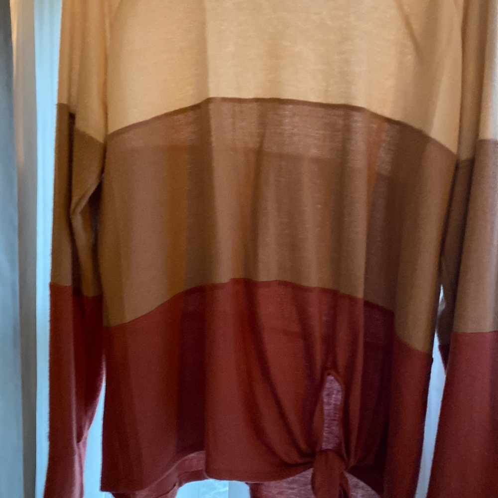 Long sleeved top. Knot front. Tri colored cream brown rust